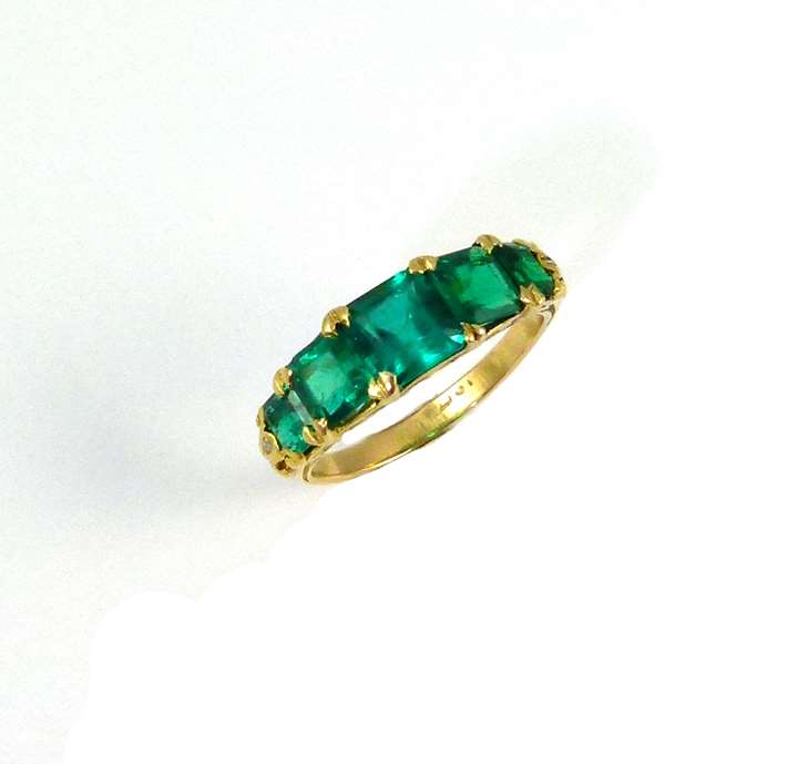 An antique emerald five stone ring.